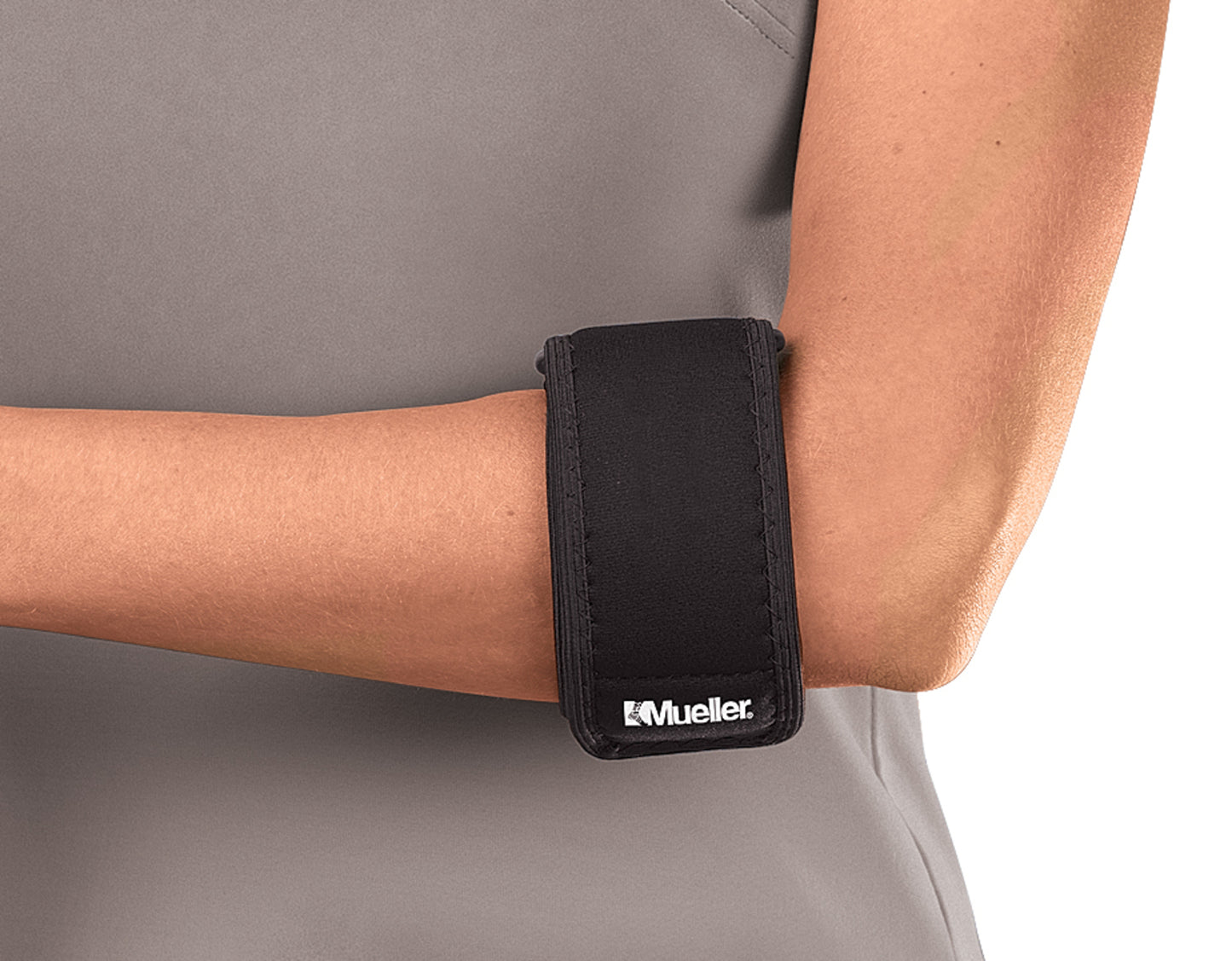 Black Mueller arm brace on a person wearing a gray shirt
