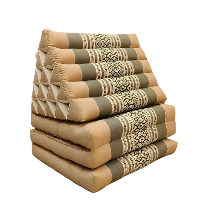 Stack of patterned cushions on a wooden floor with a neutral wall and plant in the background