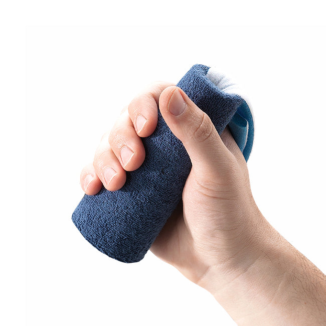 Hand holding a blue textured object against a white background