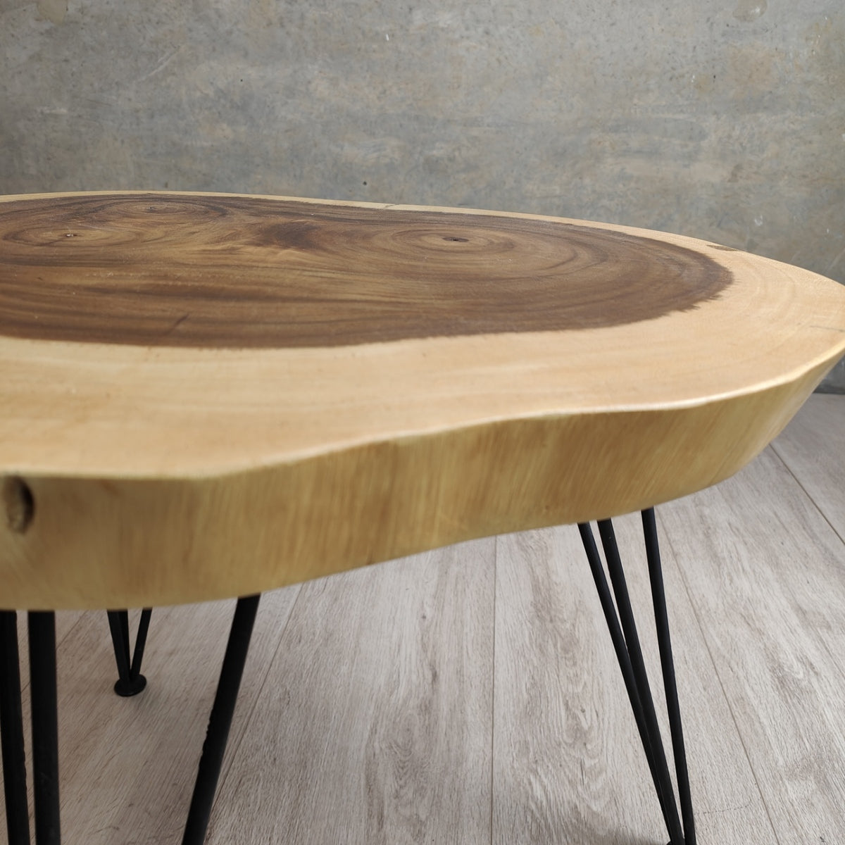 Round solid Raintree wood live edge coffee table with black metal legs