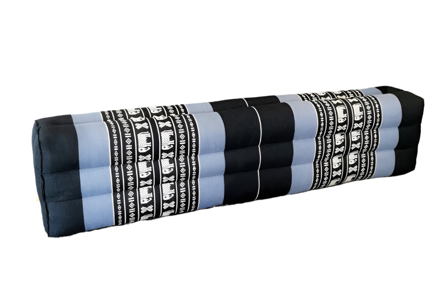 Rolled-up yoga mat with elephant pattern on a white surface with a plant in the background
