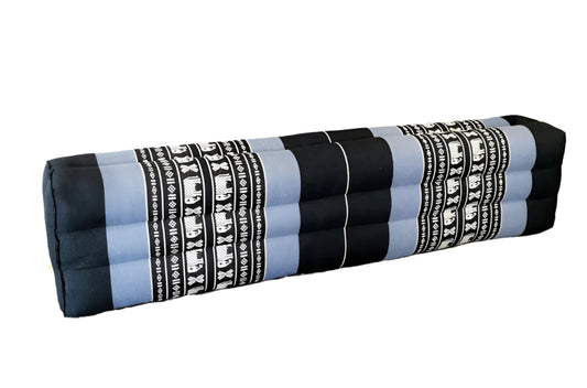 Rolled-up yoga mat with elephant pattern on a white surface with a plant in the background
