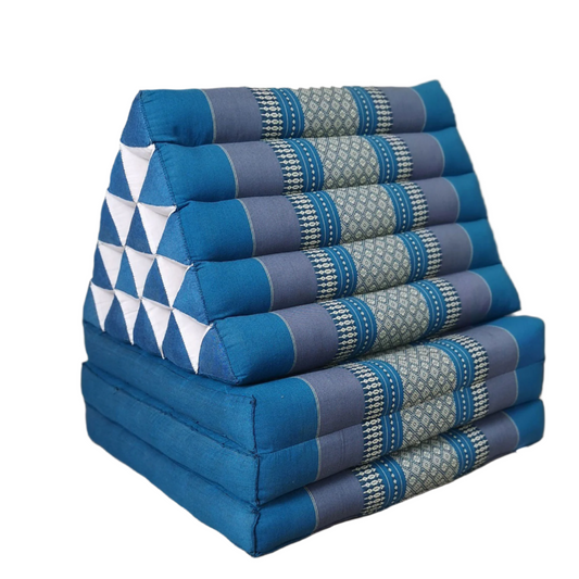 Stack of blue and gray patterned triangular cushions on a wooden floor.
