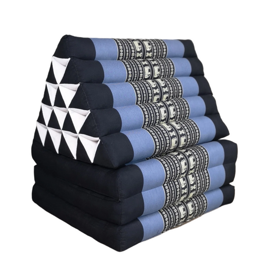 Stack of triangular cushions with geometric patterns on a wooden floor.