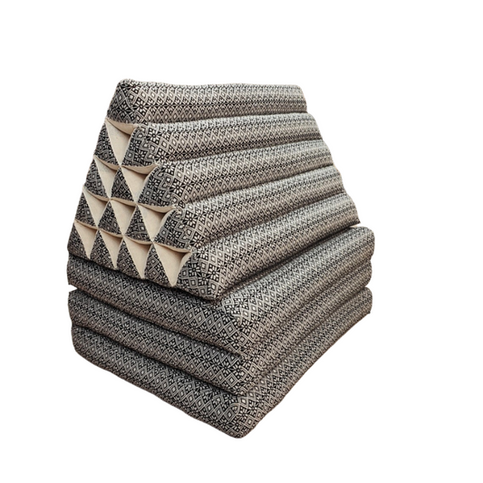 Stack of patterned cushions on a wooden floor with a neutral background