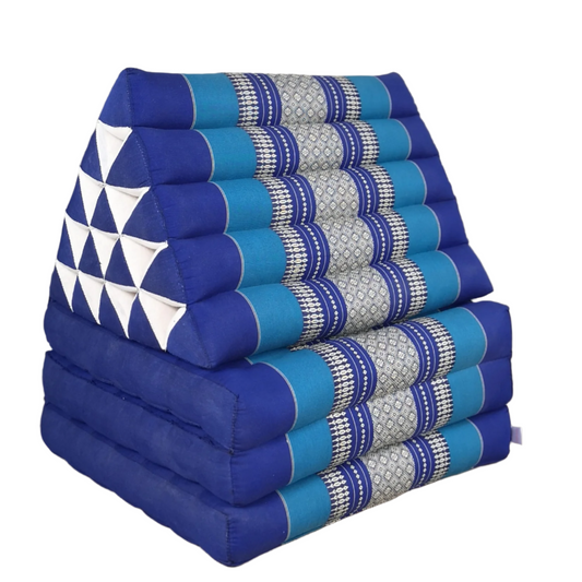 Stack of blue and patterned triangular cushions on a wooden floor.
