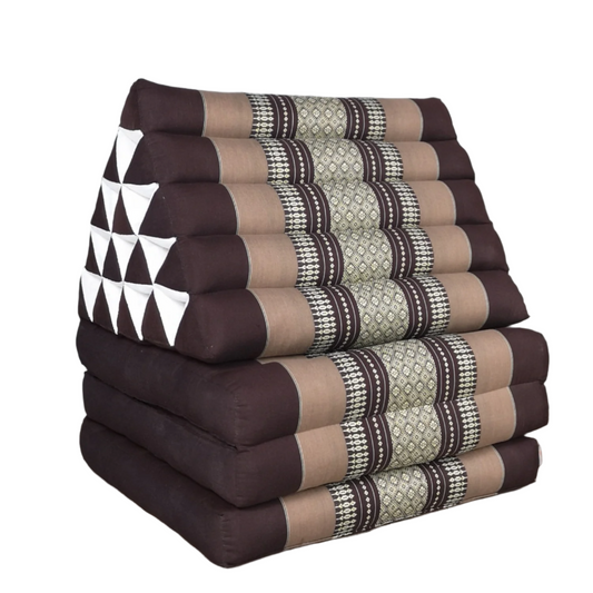 Stack of patterned triangular cushions on a wooden floor with a gray wall background