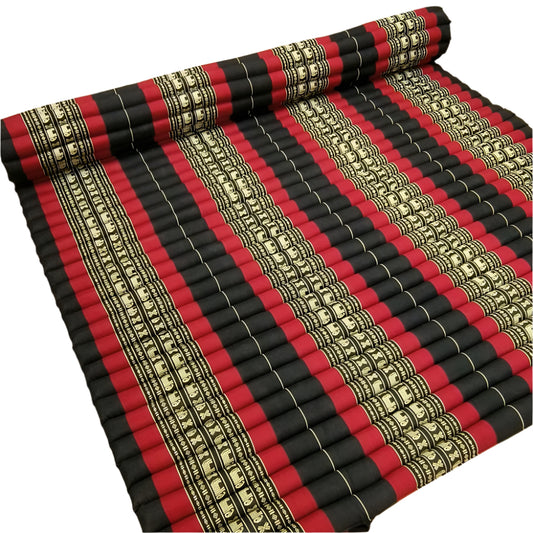 Roll of red, black, and gold striped fabric on a wooden floor.